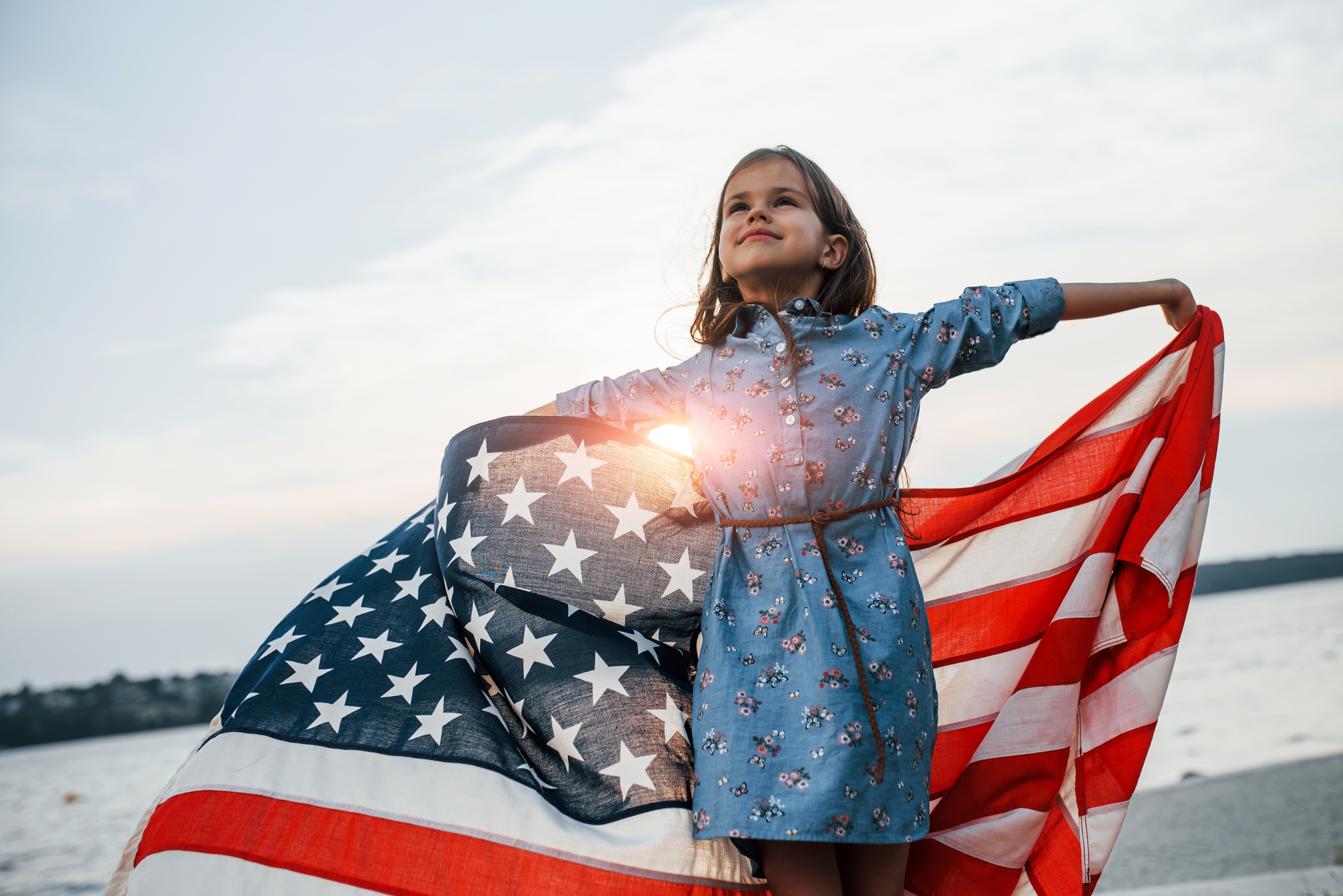 patriotic-female-kid-with-american-flag-hands (1)