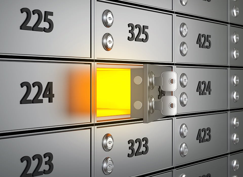 A wall of numbered safe deposit boxes with one box open and glowing yellow from within, symbolizing secure and reliable storage for your most valuable belongings.